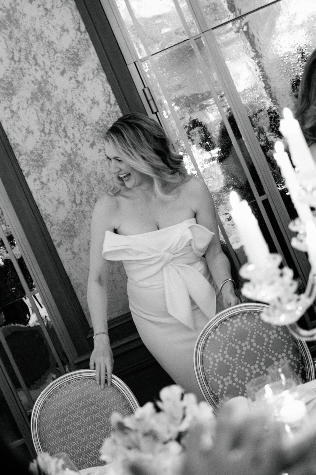 Bride listening to a speech during a candlelit Plaza Athénée wedding reception